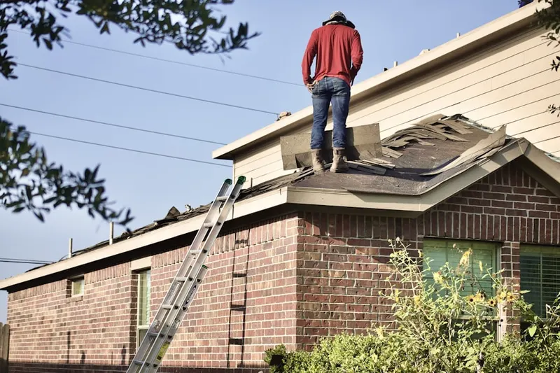 Professional roofer working on a residential roof in Staten Island Junction